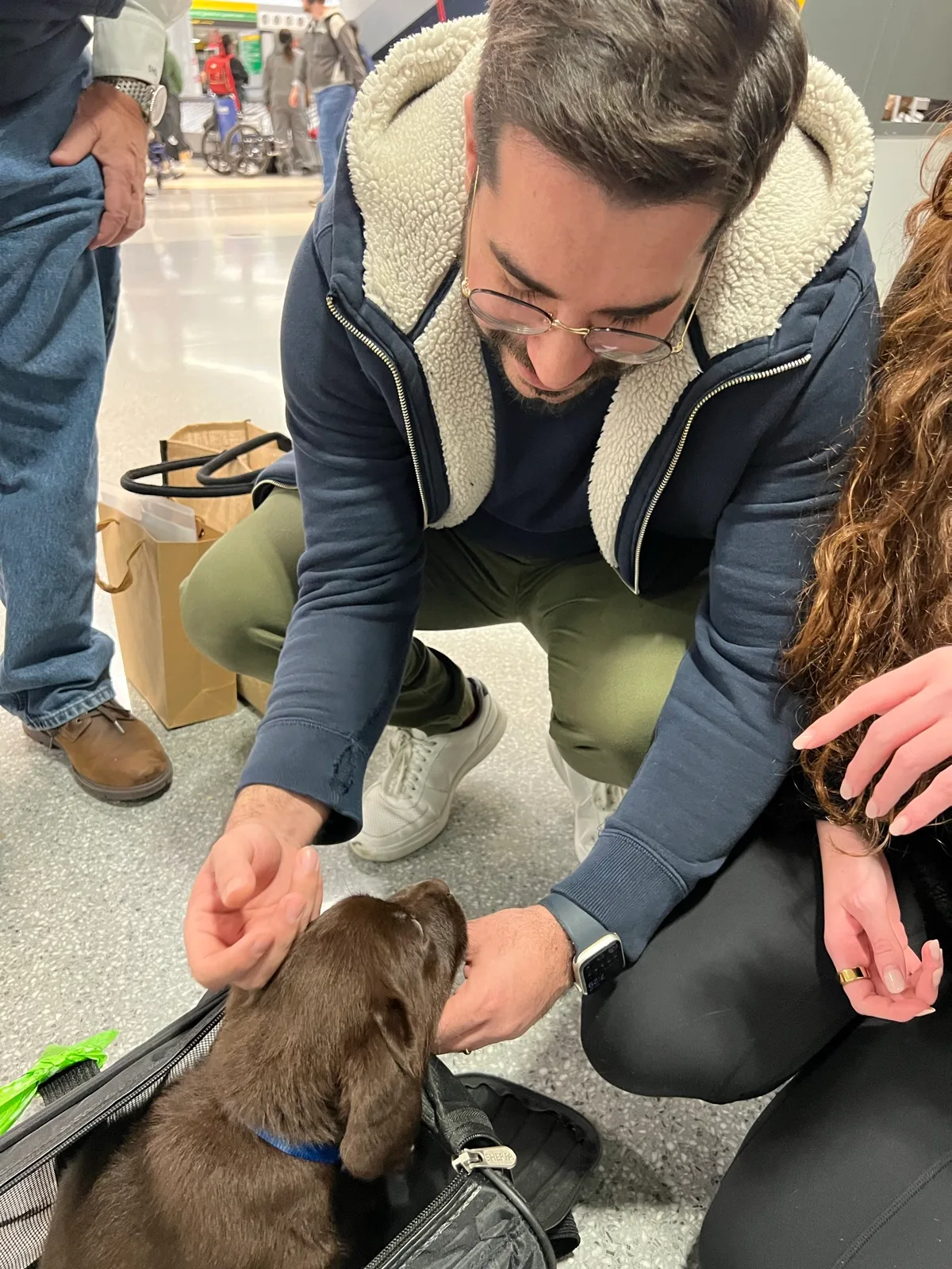 A family meeting their new Happiest Labrador puppy on gotcha day