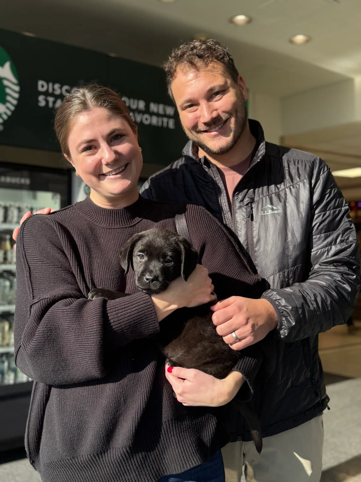 A family meeting their new Happiest Labrador puppy on gotcha day