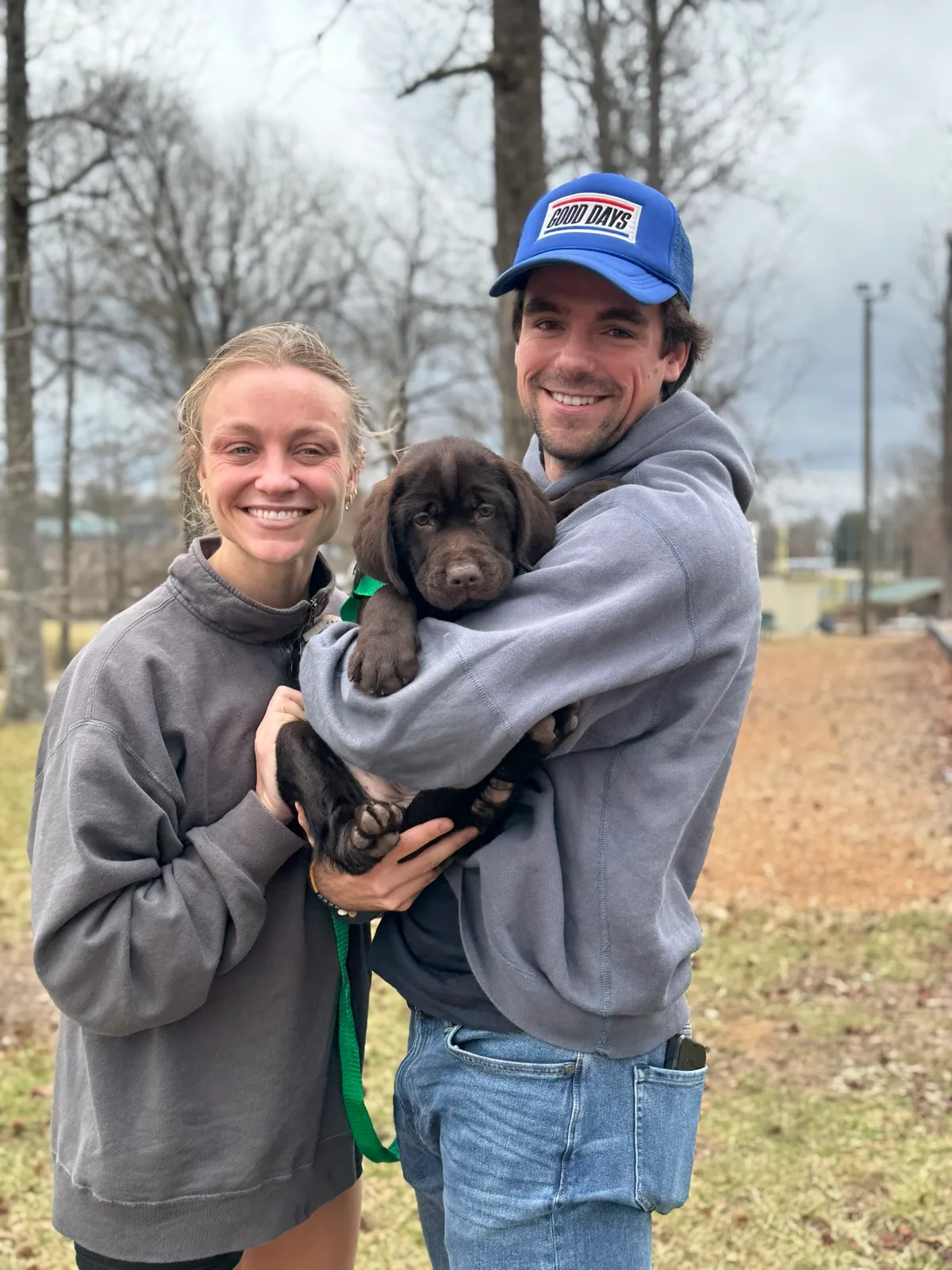 A family meeting their new Happiest Labrador puppy on gotcha day