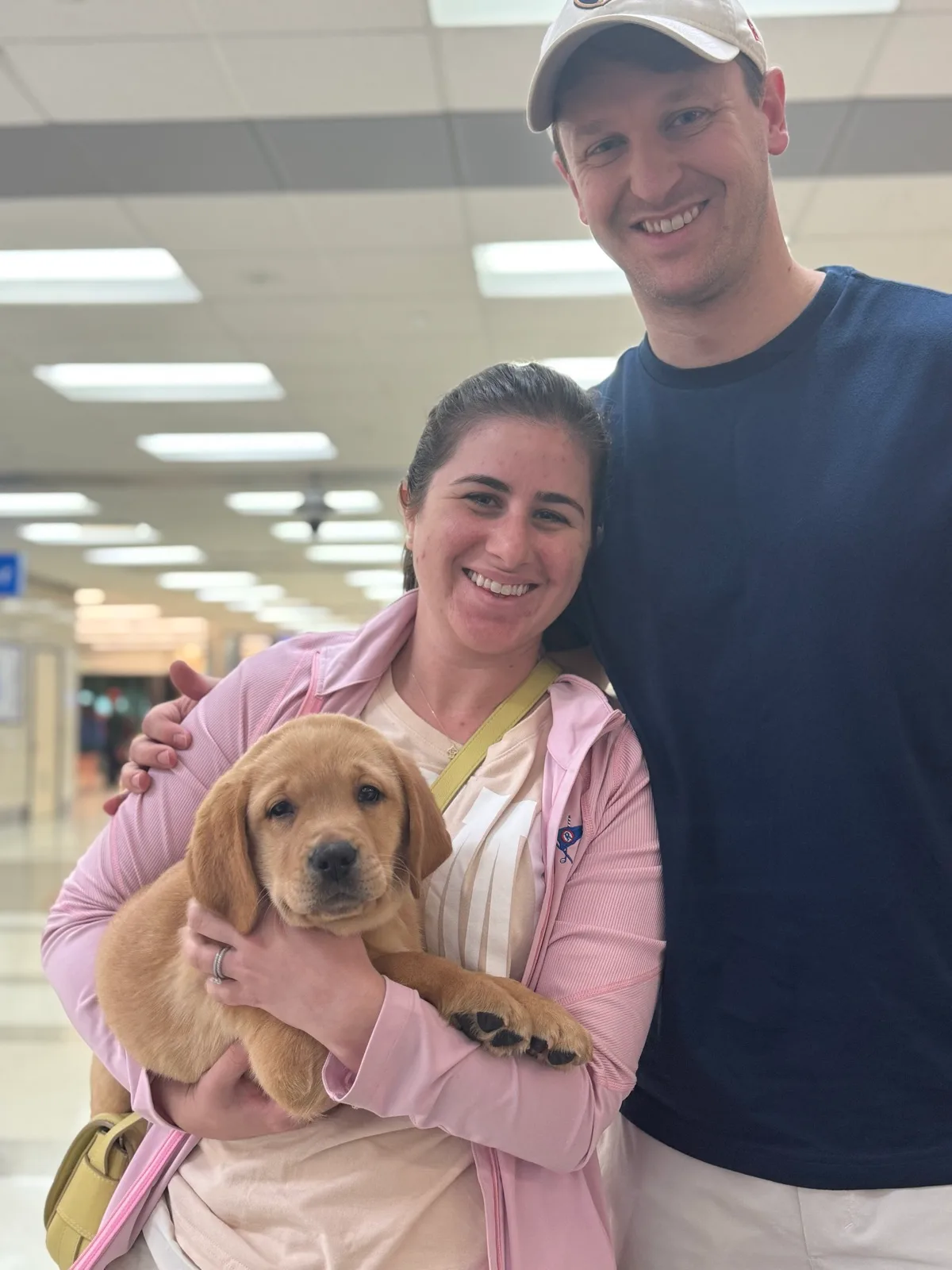 A family meeting their new Happiest Labrador puppy on gotcha day