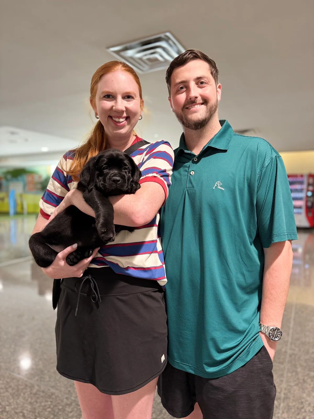 A family meeting their new Happiest Labrador puppy on gotcha day