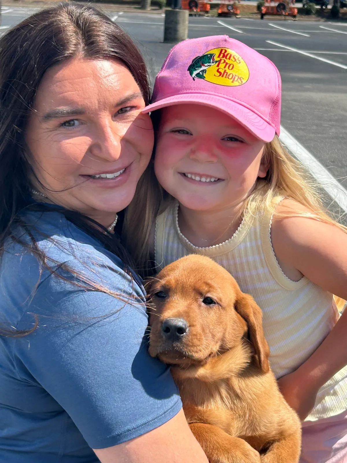 A family meeting their new Happiest Labrador puppy on gotcha day