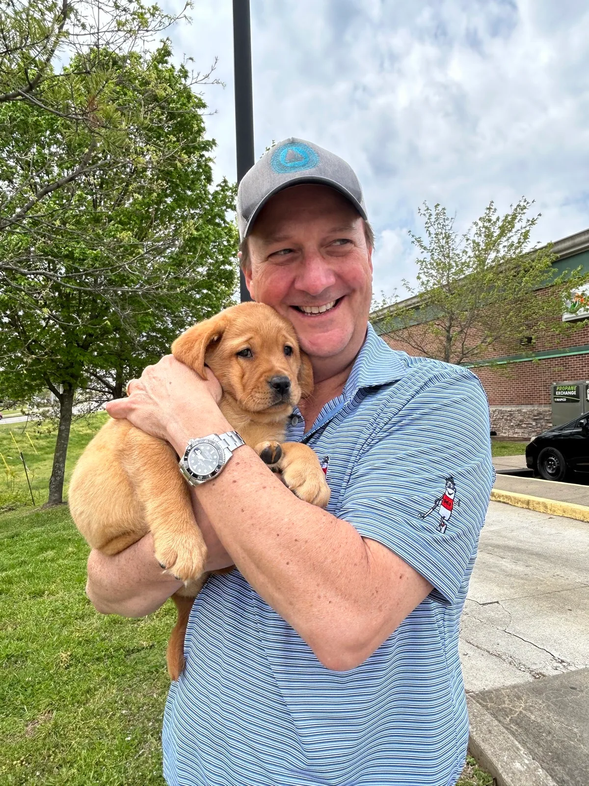 A family meeting their new Happiest Labrador puppy on gotcha day