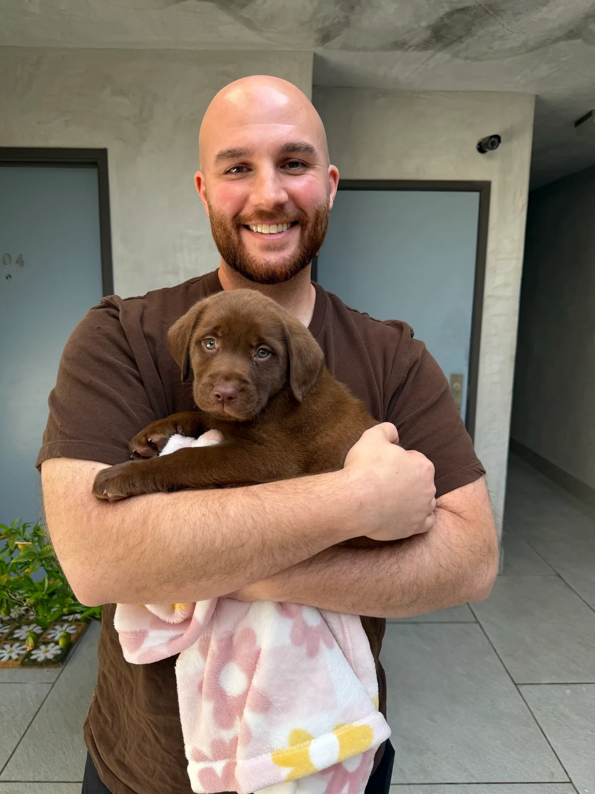 A family meeting their new Happiest Labrador puppy on gotcha day
