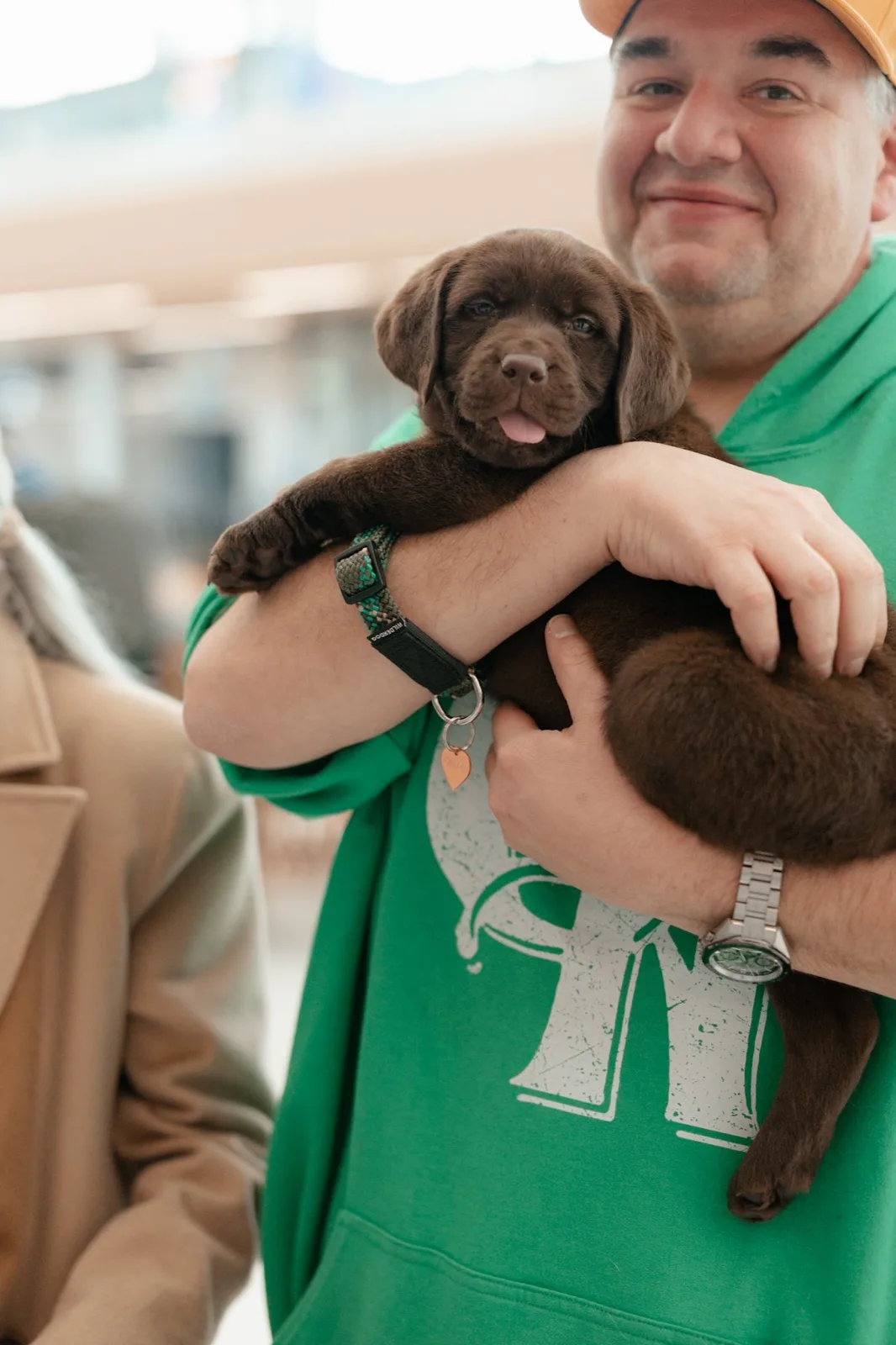 A family meeting their new Happiest Labrador puppy on gotcha day