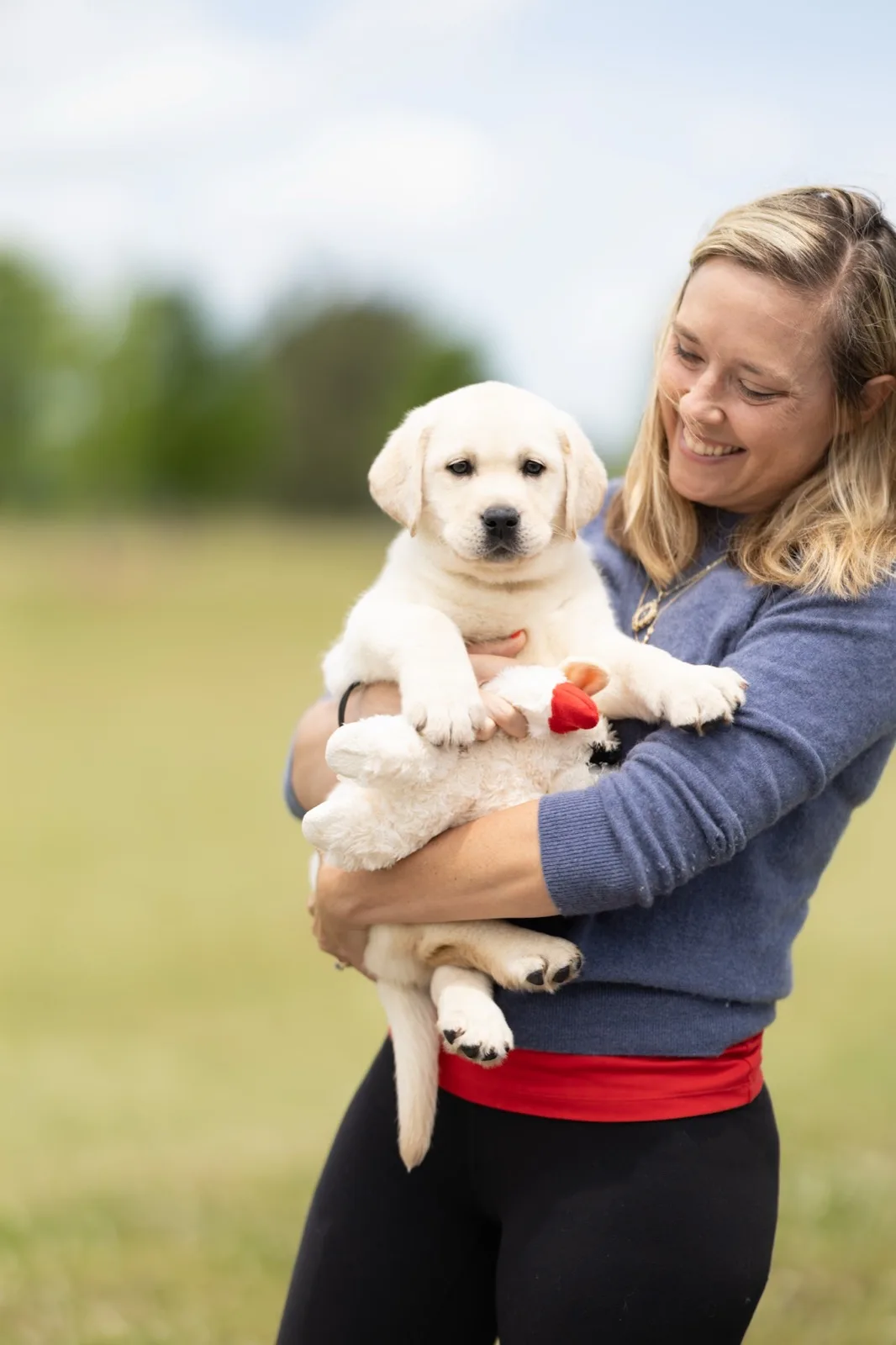A family meeting their new Happiest Labrador puppy on gotcha day